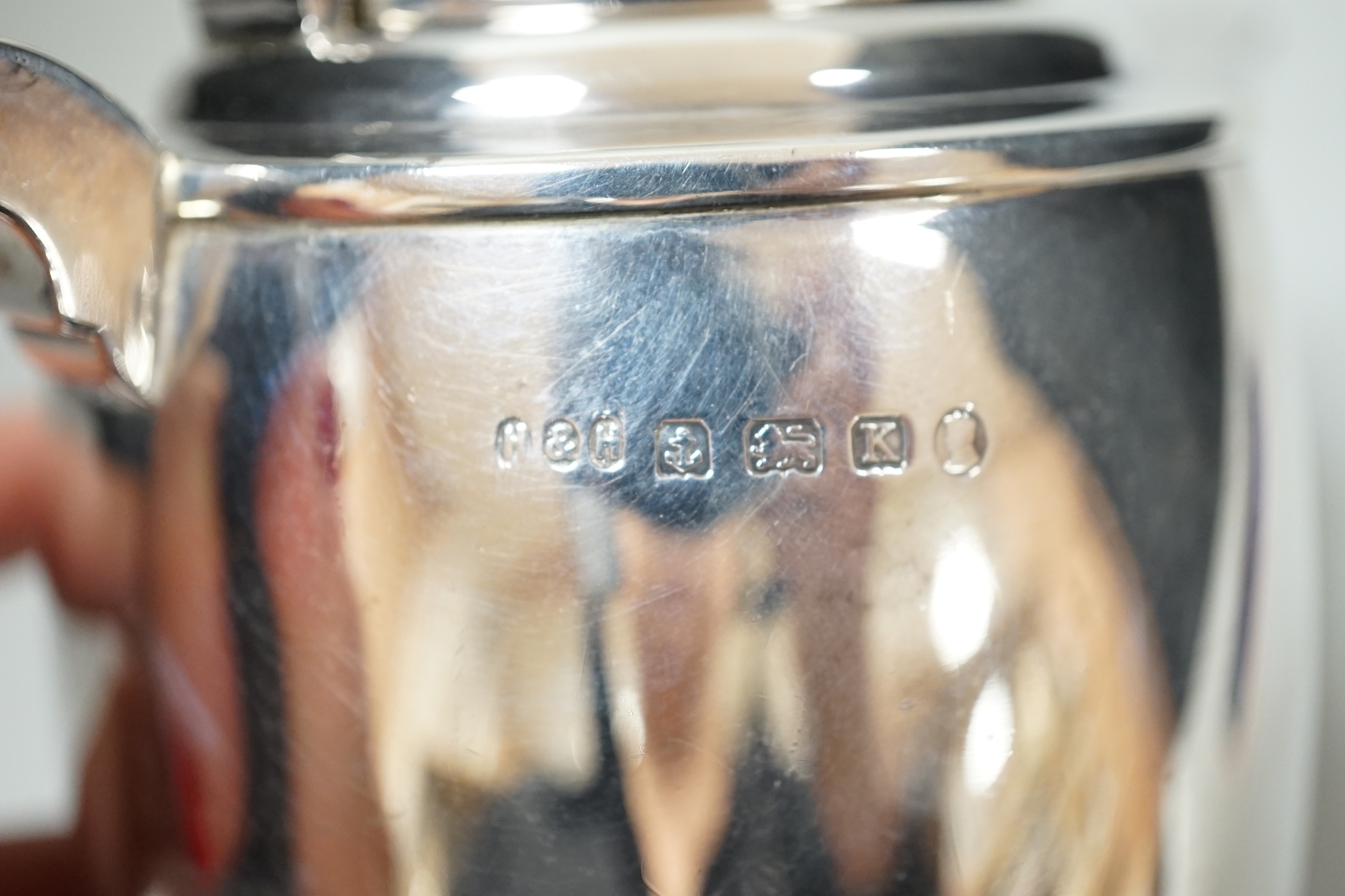 A George V silver cafe au lait pair by Hukin & Heath, Birmingham, 1934, height 15.8cm, gross weight 27.6oz.